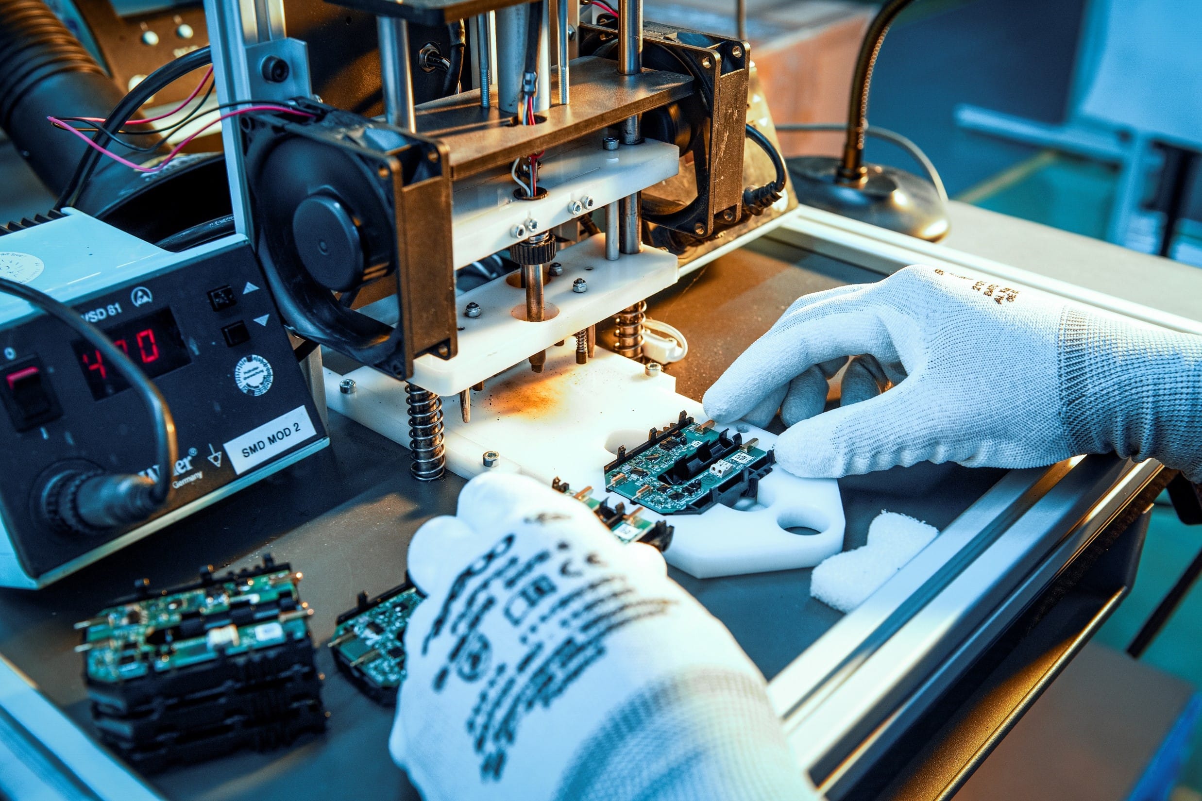 Box Build process at Variosystems: A technician carefully inserts a circuit board into a dedicated assembly station.